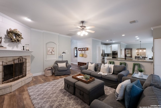 830 Emerald Bay, San Antonio, TX 78260 - living area featuring ceiling fan, wood finished floors, ornamental molding, a fireplace, and baseboards