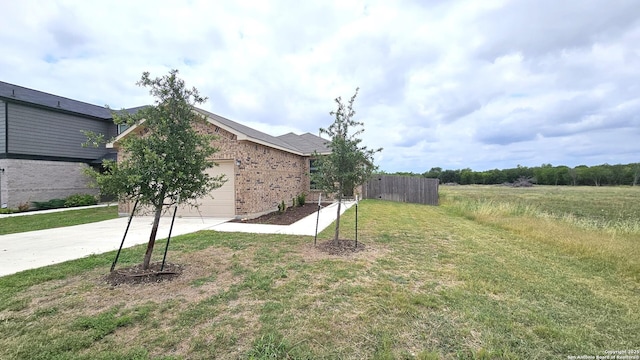 5930 Foster Bnd, San Antonio, TX 78244 - view of yard with concrete driveway and a garage