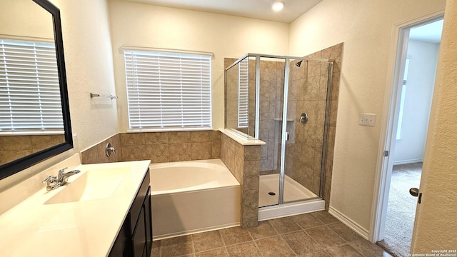 5930 Foster Bnd, San Antonio, TX 78244 - full bathroom with a garden tub, vanity, a shower stall, a textured wall, and tile patterned floors