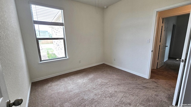 5930 Foster Bnd, San Antonio, TX 78244 - unfurnished room with dark colored carpet and baseboards