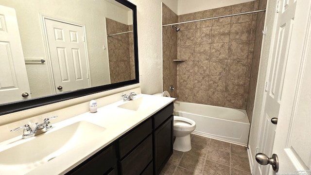 5930 Foster Bnd, San Antonio, TX 78244 - bathroom with double vanity, toilet, tub / shower combination, and a textured wall