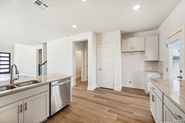 29527 Clanton Pass, San Antonio, TX 78260 - kitchen with dishwasher, a sink, baseboards, light stone countertops, and light wood finished floors