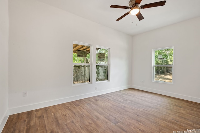 101 New York, San Antonio, TX 78214 - unfurnished room featuring healthy amount of natural light, wood finished floors, a ceiling fan, and baseboards