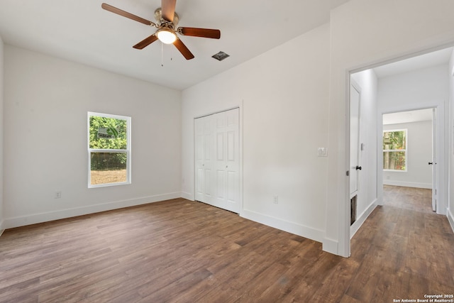 101 New York, San Antonio, TX 78214 - unfurnished bedroom featuring multiple windows, wood finished floors, baseboards, and a closet