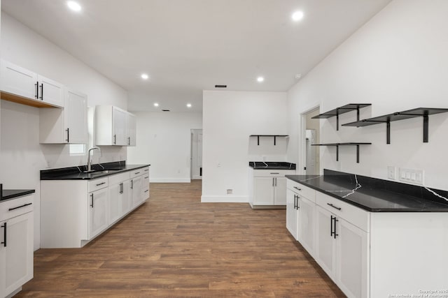 101 New York, San Antonio, TX 78214 - kitchen with a sink, open shelves, dark countertops, recessed lighting, and dark wood finished floors