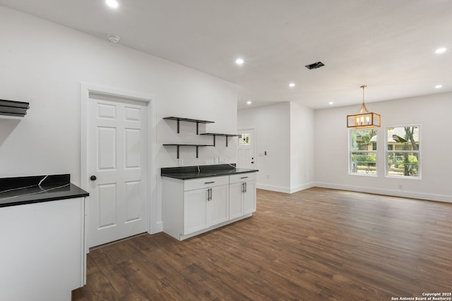 101 New York, San Antonio, TX 78214 - kitchen with open shelves, dark countertops, dark wood finished floors, white cabinets, and recessed lighting