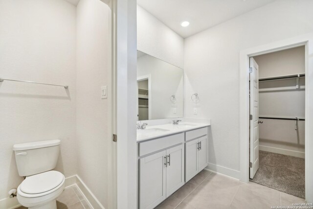 29508 Ringo Way, San Antonio, TX 78260 - bathroom featuring double vanity, a walk in closet, and baseboards