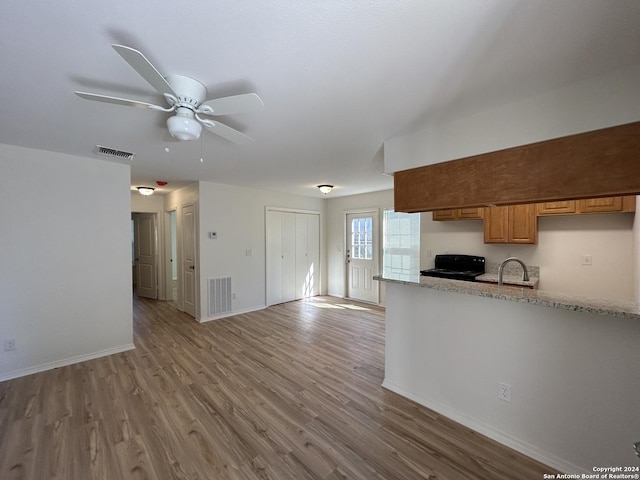 1807 Fresno, San Antonio, TX 78201 - kitchen featuring stove, light wood-type flooring, a sink, and baseboards