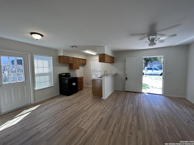 1807 Fresno, San Antonio, TX 78201 - kitchen featuring open floor plan, brown cabinets, wood finished floors, and baseboards