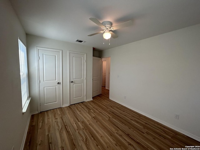 1807 Fresno, San Antonio, TX 78201 - unfurnished bedroom with baseboards, dark wood-style floors, and a ceiling fan