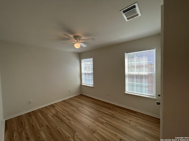 1807 Fresno, San Antonio, TX 78201 - unfurnished room featuring a ceiling fan, wood finished floors, and baseboards
