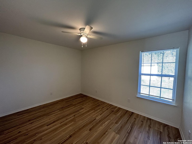 1807 Fresno, San Antonio, TX 78201 - empty room with dark wood finished floors, ceiling fan, and baseboards