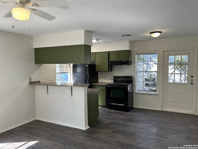 1807 Fresno, San Antonio, TX 78201 - kitchen with black appliances, a peninsula, green cabinets, dark wood-style flooring, and a breakfast bar area