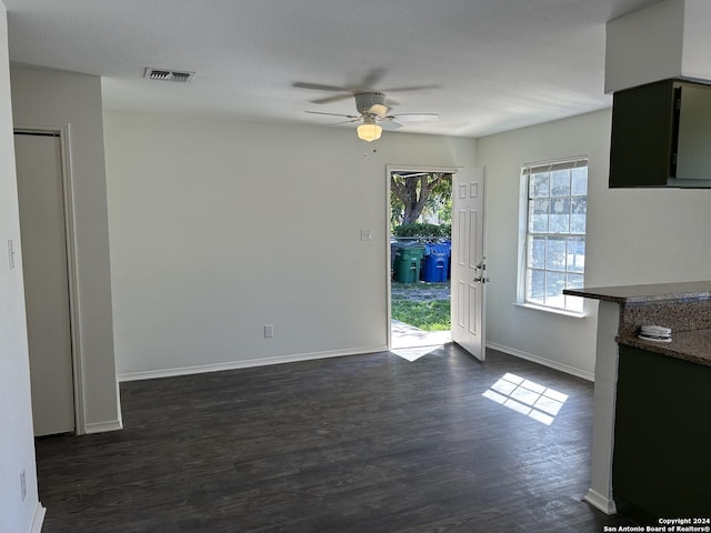 1807 Fresno, San Antonio, TX 78201 - unfurnished living room featuring a ceiling fan, dark wood-type flooring, and baseboards