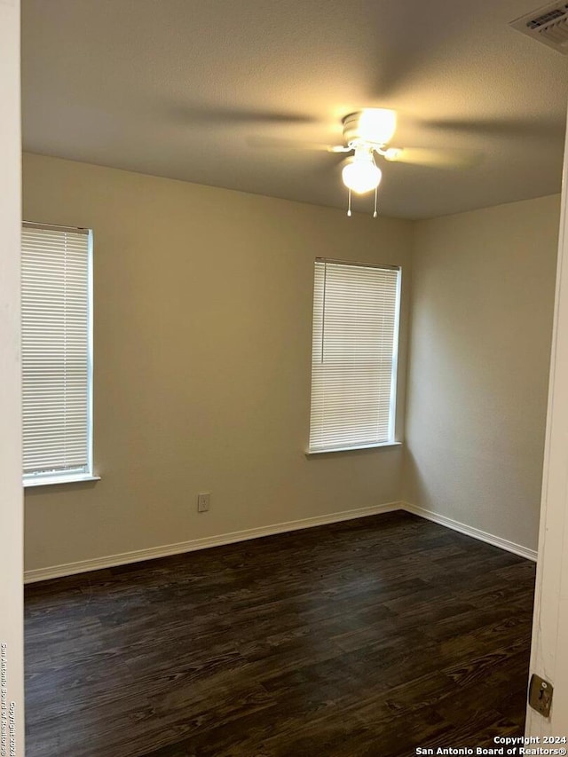 1807 Fresno, San Antonio, TX 78201 - unfurnished room featuring dark wood-type flooring, ceiling fan, and baseboards