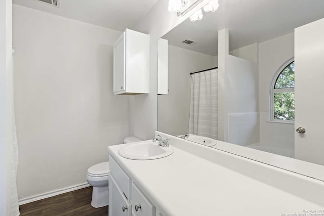 1011 Cat Mesa, San Antonio, TX 78251 - full bathroom with toilet, wood finished floors, vanity, baseboards, and curtained shower