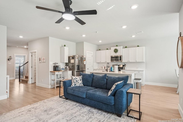 4538 Nueces, San Antonio, TX 78253 - living room featuring light wood finished floors, baseboards, a ceiling fan, recessed lighting, and stairs