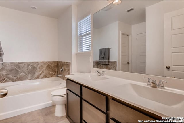 3951 Gentle Mdw, New Braunfels, TX 78130 - bathroom featuring a bath, toilet, double vanity, tile patterned floors, and a closet