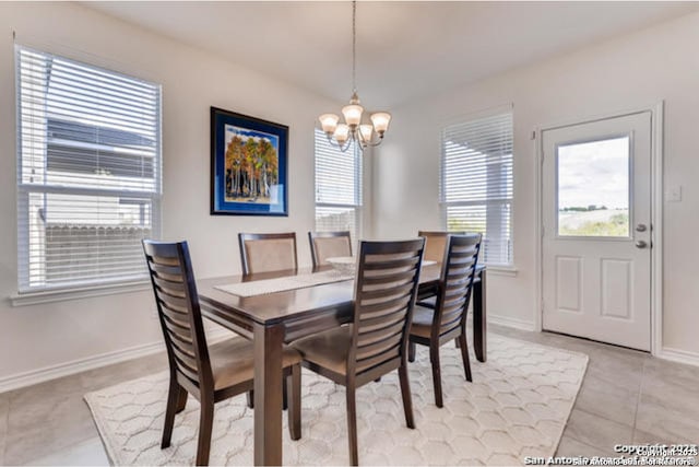 3951 Gentle Mdw, New Braunfels, TX 78130 - dining space featuring a chandelier, plenty of natural light, light tile patterned floors, and baseboards