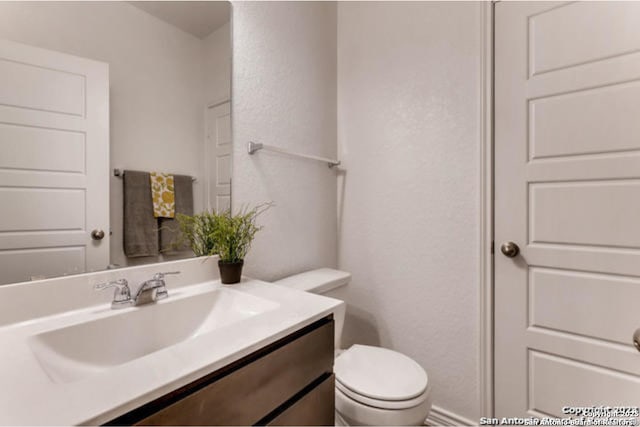 3951 Gentle Mdw, New Braunfels, TX 78130 - half bathroom with vanity, toilet, and a textured wall
