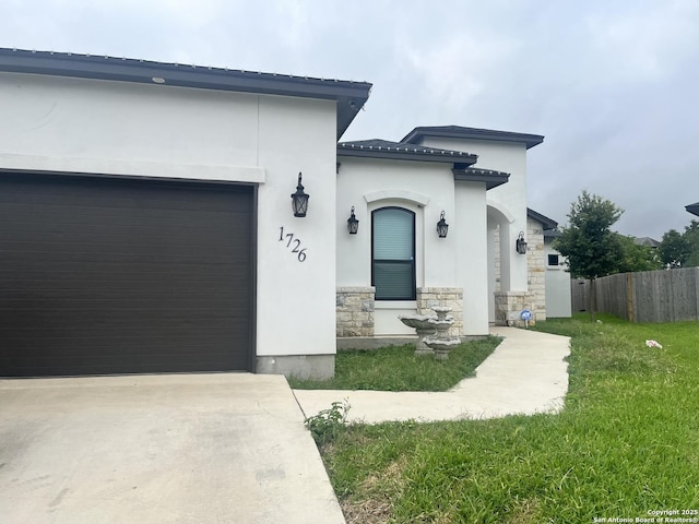 1726 Claudia Vis, San Antonio, TX 78224 - view of front of house with stone siding, stucco siding, an attached garage, and driveway