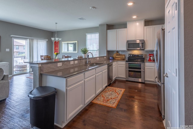 7566 Copper Kettle, Converse, TX 78109 - kitchen featuring stainless steel appliances, a sink, white cabinetry, dark wood finished floors, and recessed lighting