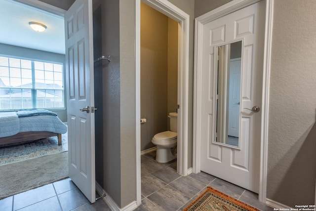 7566 Copper Kettle, Converse, TX 78109 - bathroom with toilet, a textured wall, tile patterned floors, and baseboards