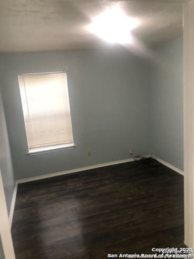1815 Fresno, San Antonio, TX 78201 - empty room featuring baseboards and dark wood-style floors