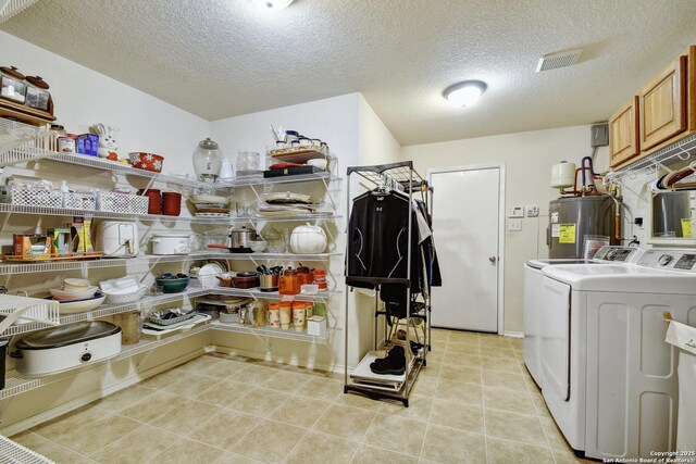 181 Foxglove, Cibolo, TX 78108 - laundry area featuring independent washer and dryer, electric water heater, cabinet space, a textured ceiling, and light tile patterned floors