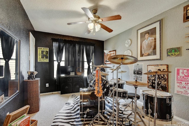 181 Foxglove, Cibolo, TX 78108 - playroom with a textured wall, a ceiling fan, a textured ceiling, carpet, and baseboards