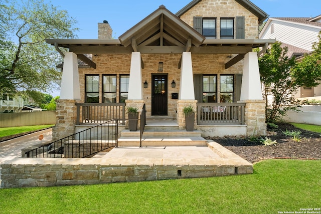 228 Cloverleaf, Alamo Heights, TX 78209 - view of front facade with stone siding, a chimney, and covered porch