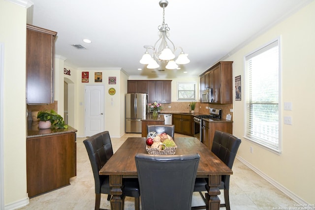 414 Aspen, San Antonio, TX 78253 - dining area featuring a chandelier, crown molding, baseboards, arched walkways, and recessed lighting