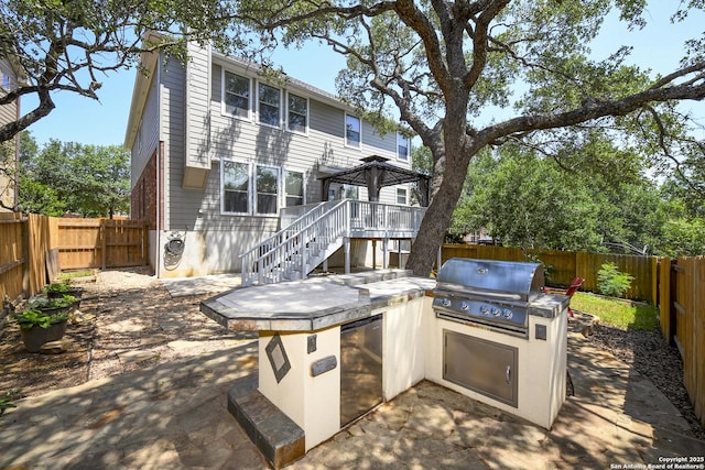 414 Aspen, San Antonio, TX 78253 - back of property featuring a fenced backyard, exterior kitchen, stairway, and a patio
