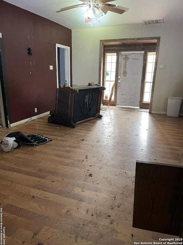 439 W Lubbock St, San Antonio, TX 78204 - entrance foyer featuring hardwood / wood-style flooring, a ceiling fan, baseboards, and a wood stove
