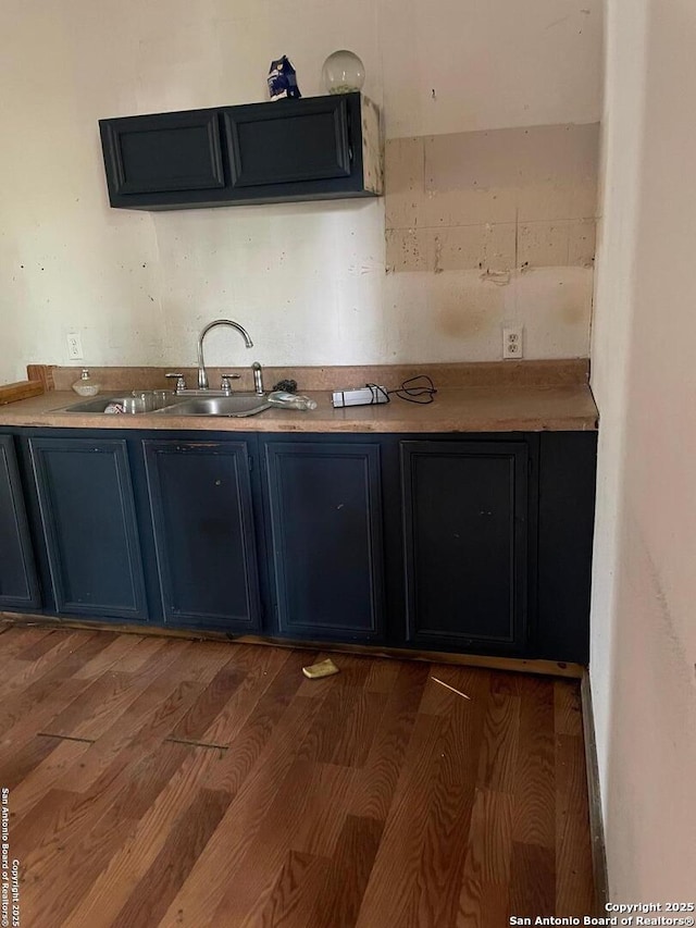 439 W Lubbock St, San Antonio, TX 78204 - kitchen featuring blue cabinetry, a sink, wood finished floors, and light countertops