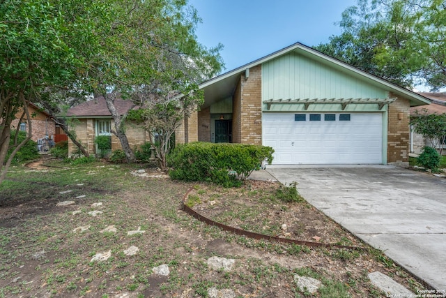 15314 Artesian Oaks, San Antonio, TX 78232 - view of front facade with an attached garage, brick siding, and driveway