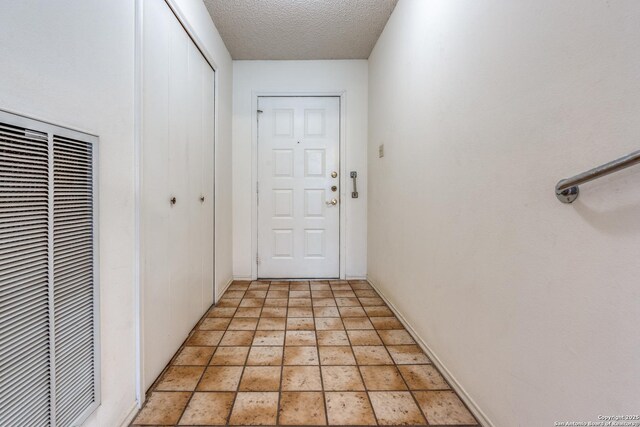 15314 Artesian Oaks, San Antonio, TX 78232 - corridor featuring a heating unit, light stone finish flooring, a textured ceiling, and baseboards
