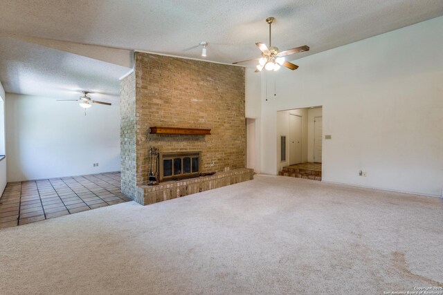 15314 Artesian Oaks, San Antonio, TX 78232 - unfurnished living room with a ceiling fan, carpet, a textured ceiling, a fireplace, and a towering ceiling