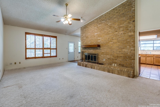 15314 Artesian Oaks, San Antonio, TX 78232 - unfurnished living room featuring a textured ceiling, a ceiling fan, lofted ceiling, a fireplace, and light carpet