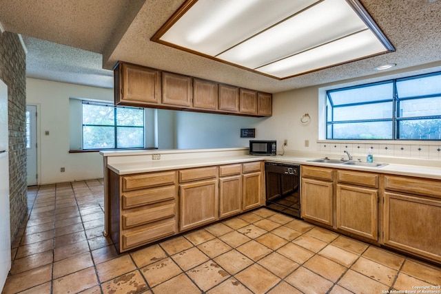 15314 Artesian Oaks, San Antonio, TX 78232 - kitchen with black appliances, a peninsula, a sink, a textured ceiling, and light countertops