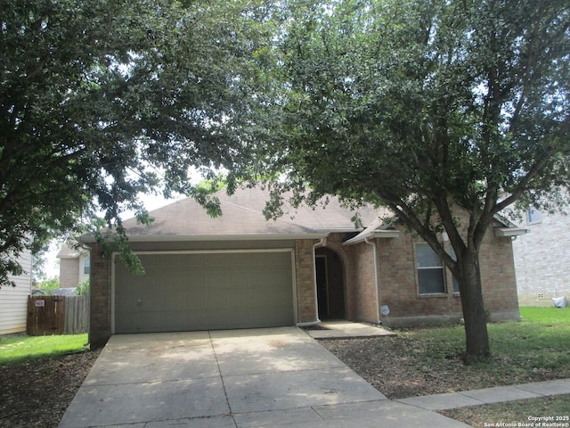 11011 Crystal Pln, Live Oak, TX 78233 - view of front of home with an attached garage, concrete driveway, and brick siding