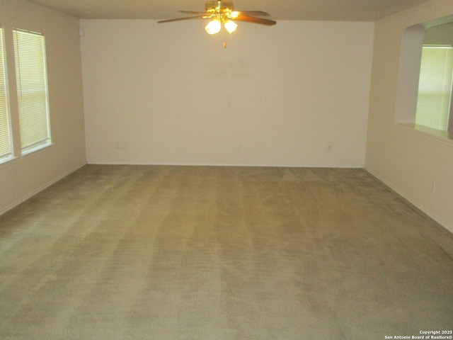 11011 Crystal Pln, Live Oak, TX 78233 - empty room featuring ceiling fan, light colored carpet, arched walkways, and plenty of natural light
