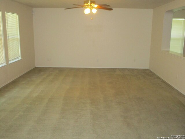 11011 Crystal Pln, Live Oak, TX 78233 - empty room featuring ceiling fan, light colored carpet, arched walkways, and plenty of natural light