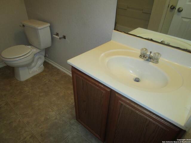 11011 Crystal Pln, Live Oak, TX 78233 - bathroom featuring vanity, baseboards, toilet, and tile patterned flooring