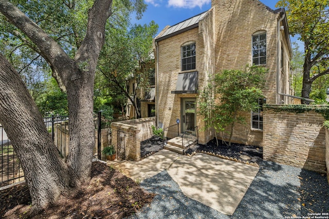 209 Chichester Pl Unit 1, San Antonio, TX 78209 - view of front of house featuring a standing seam roof, brick siding, and metal roof