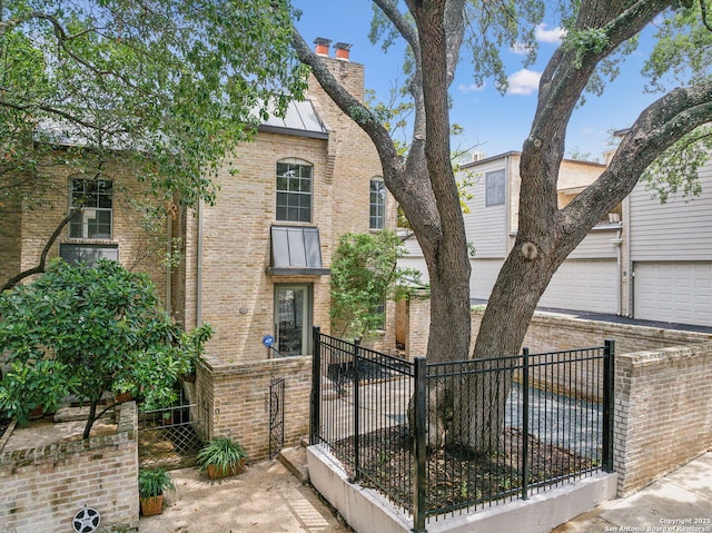 209 Chichester Pl Unit 1, San Antonio, TX 78209 - view of front facade with brick siding, a chimney, and a garage