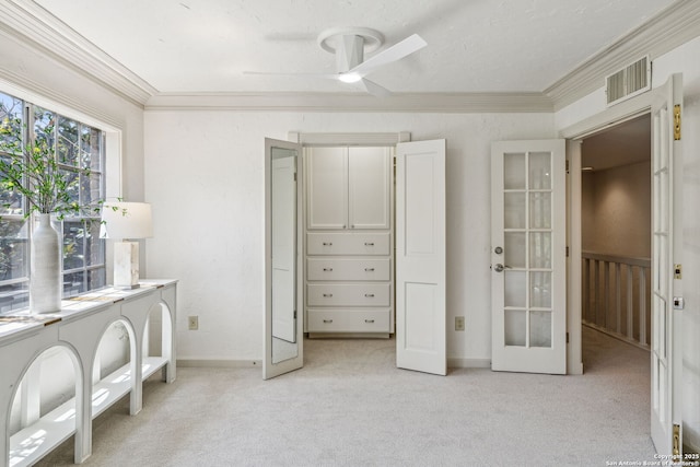 209 Chichester Pl Unit 1, San Antonio, TX 78209 - bedroom featuring french doors, crown molding, light carpet, baseboards, and a ceiling fan