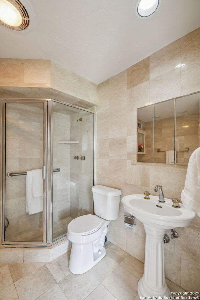 209 Chichester Pl Unit 1, San Antonio, TX 78209 - bathroom featuring tile walls, toilet, a stall shower, and tile patterned floors