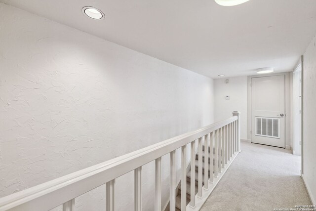 209 Chichester Pl Unit 1, San Antonio, TX 78209 - hall with an upstairs landing and light colored carpet
