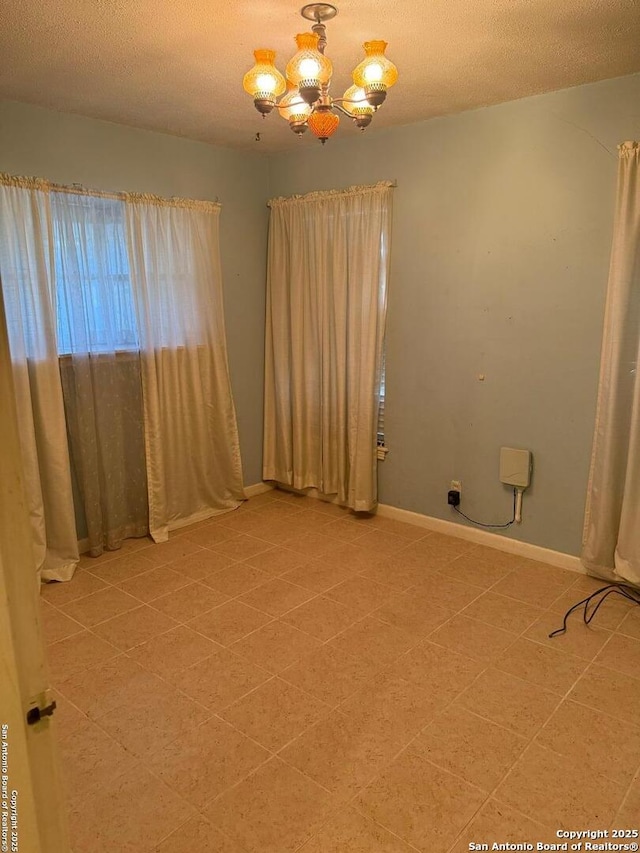 254 W Greenway Ave, San Antonio, TX 78226 - spare room with a chandelier, baseboards, and a textured ceiling